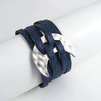 Blue leather bracelet with silver leaf-like clasps on a white background