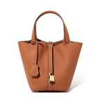 Brown leather handbag with a gold lock on a white background