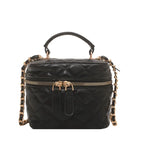 Black quilted handbag with gold chain strap on a white background