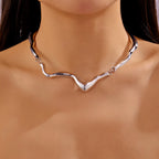 Silver necklace on a mannequin with a dark background