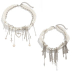 Two pearl necklaces with fringe details on a white background