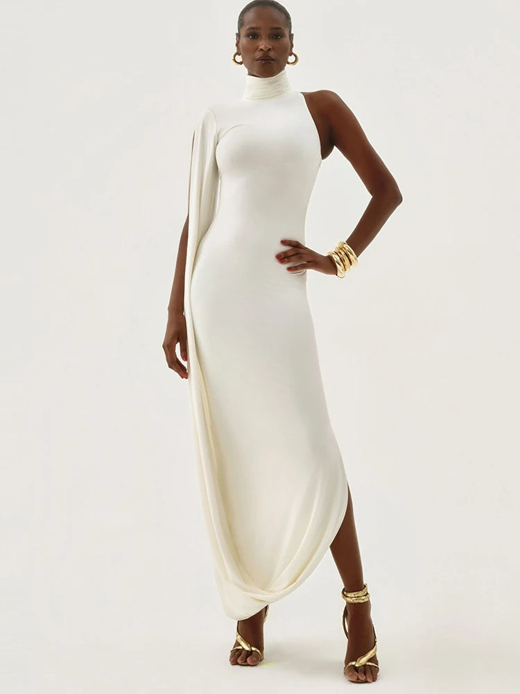 Woman wearing a white dress with gold shoes on a white background