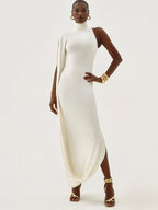 Woman wearing a white dress with gold shoes on a white background