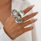Silver ring on a hand with a blurred background