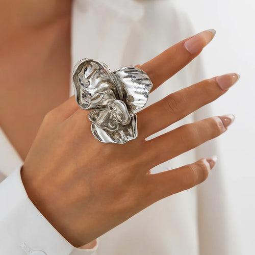 Silver ring on a hand with a blurred background