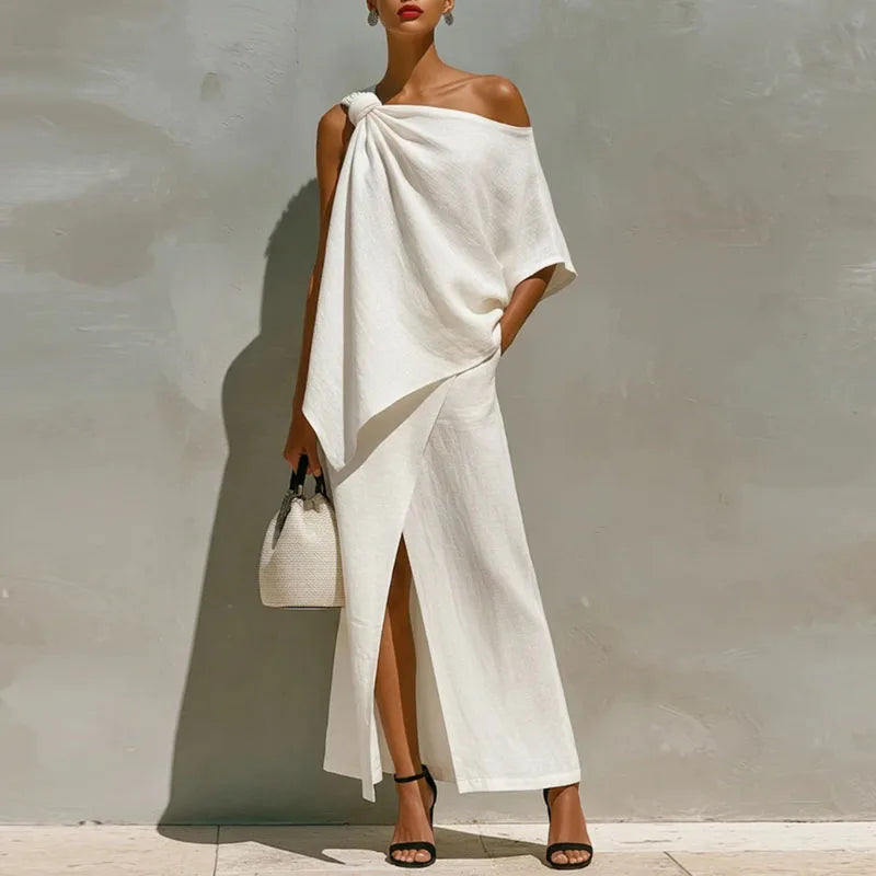 Woman wearing a white off-shoulder dress with a plain background