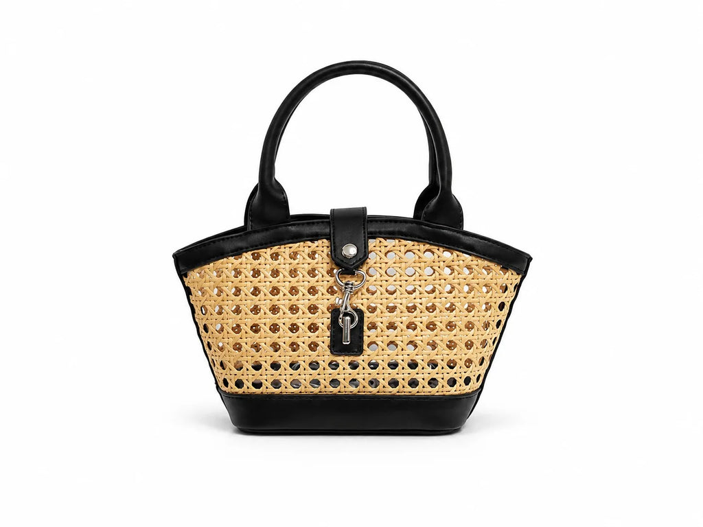 Handbag with black leather top handle and wicker body on a white background
