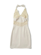 White halter neck dress with lace detailing on a white background