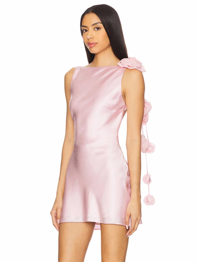 Pink satin dress with ruffled shoulders on a white background