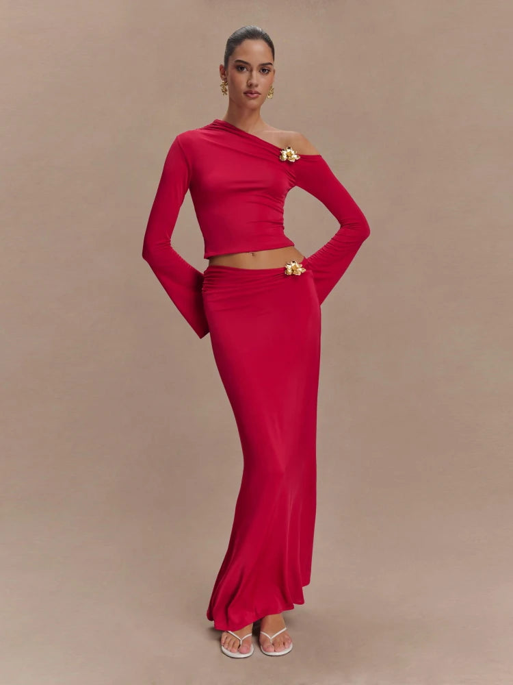 Woman wearing a red outfit with a gold belt on a beige background