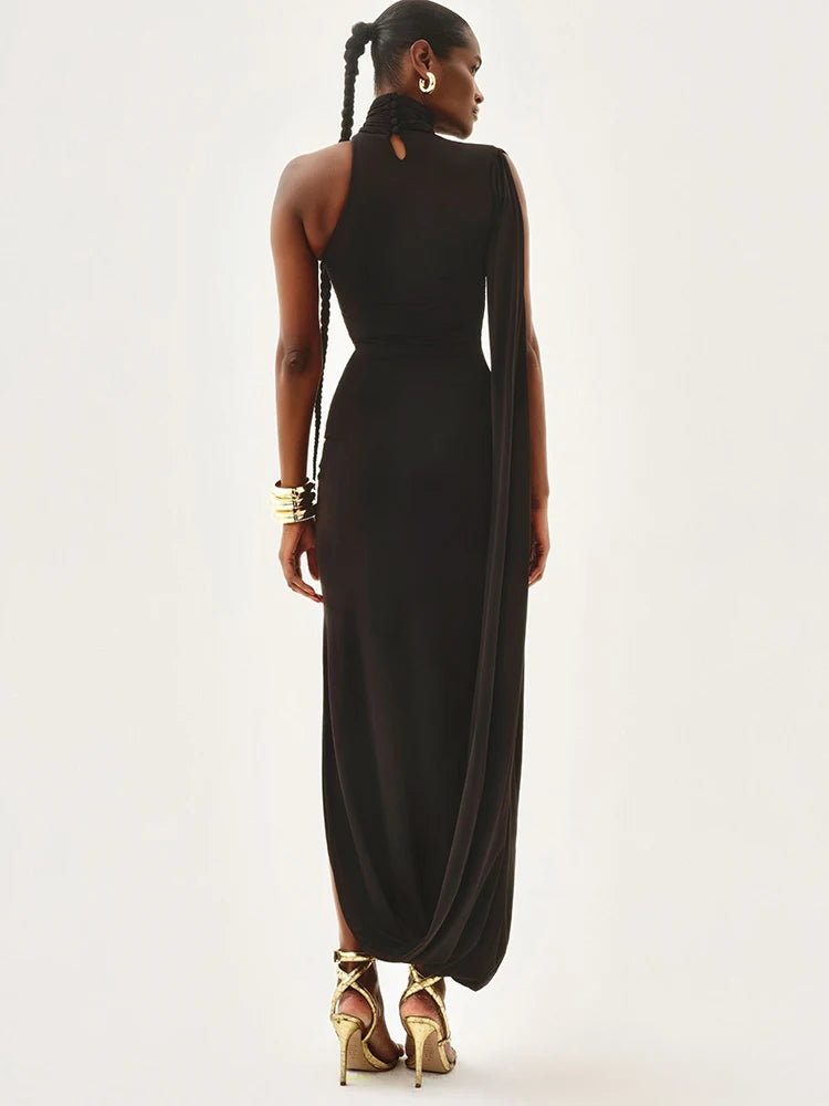 Woman wearing a black halter neck gown on a white background