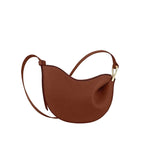 Brown handbag with a strap on a light beige background