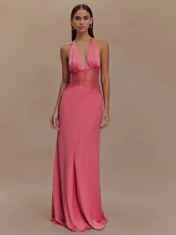 Woman wearing a pink halter neck gown against a beige background