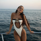 Woman in a stylish swimsuit on a boat with ocean background
