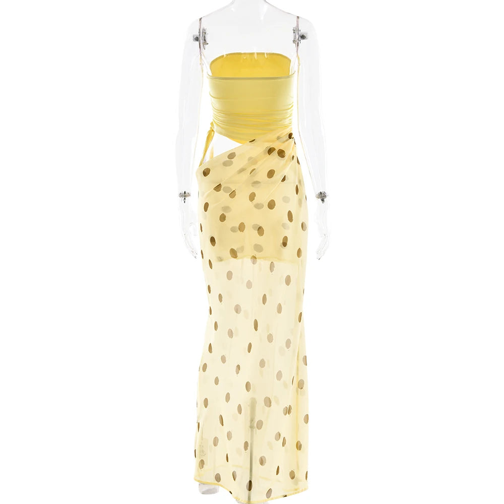 Yellow polka dot dress with clear plastic cover on a white background