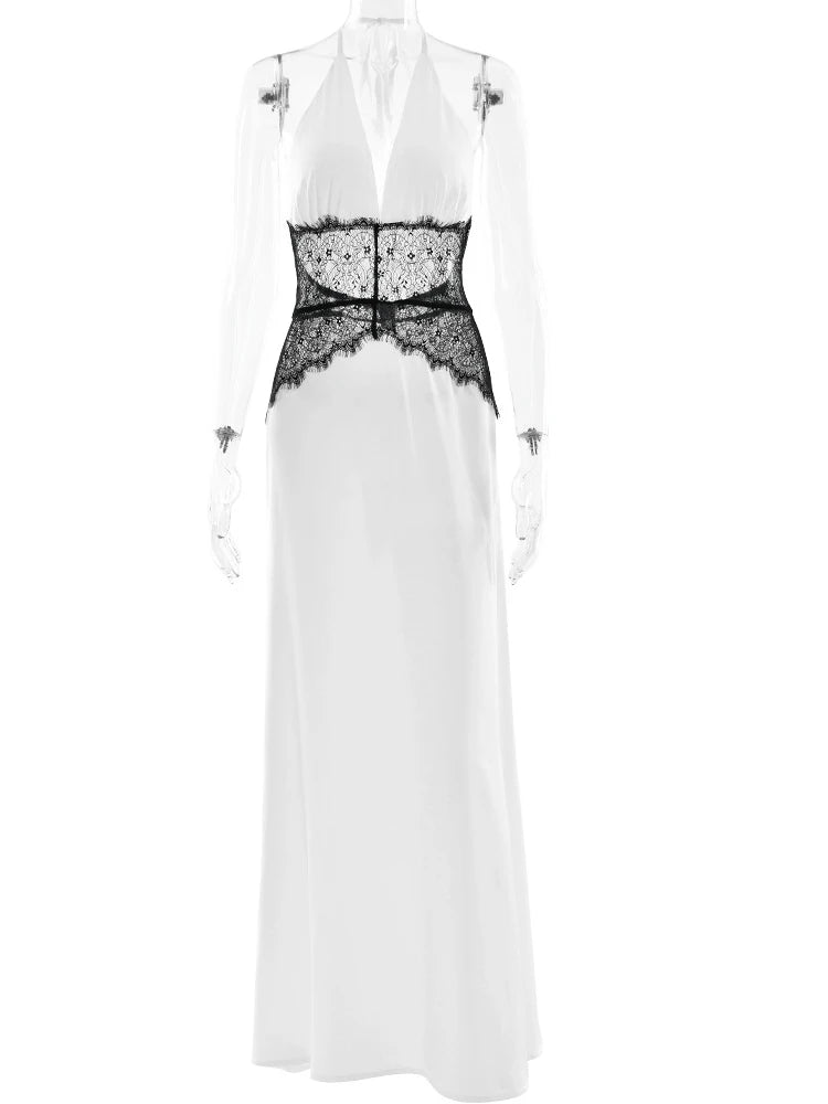 White dress with black lace detailing on a white background