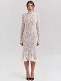 Woman wearing a white lace dress on a light gray background