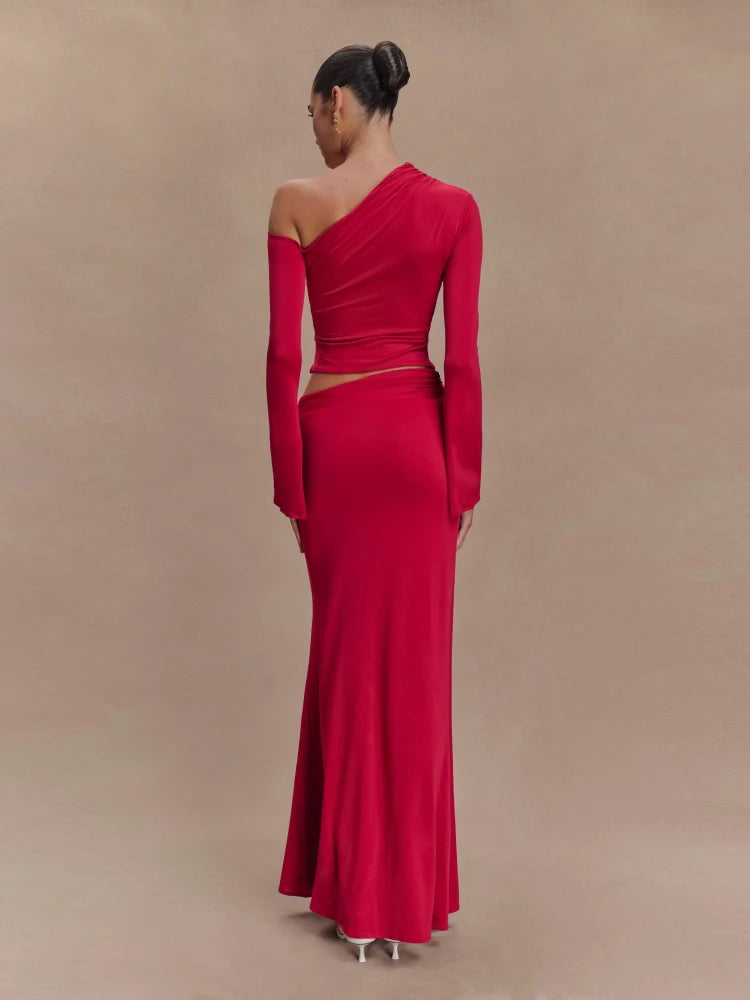 Red one-shoulder evening gown on a model against a beige background