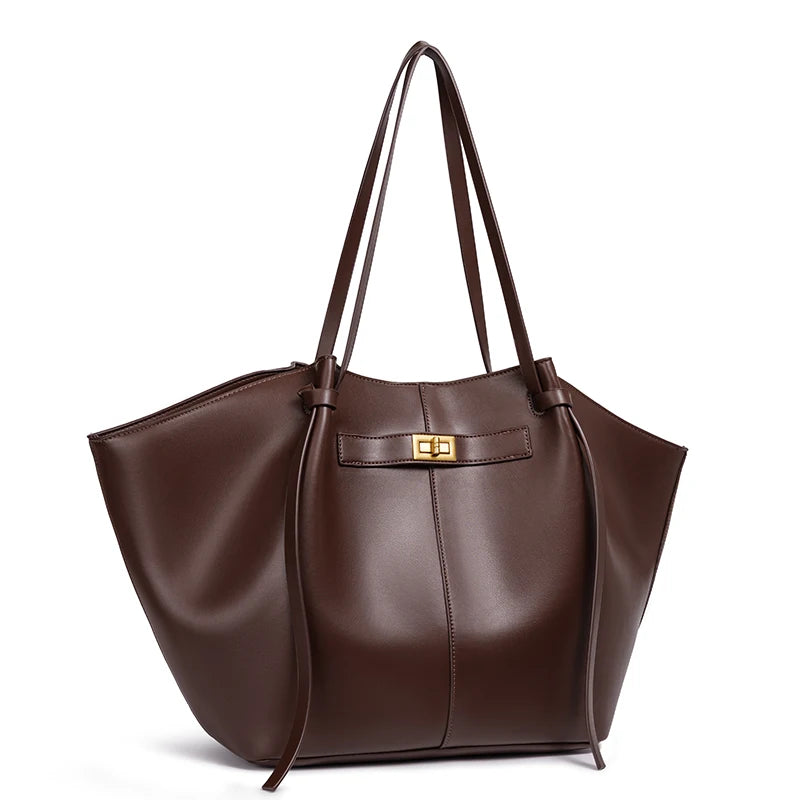 Brown leather handbag with a gold clasp on a white background