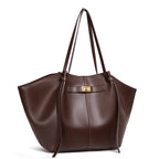 Brown leather handbag with a gold clasp on a white background