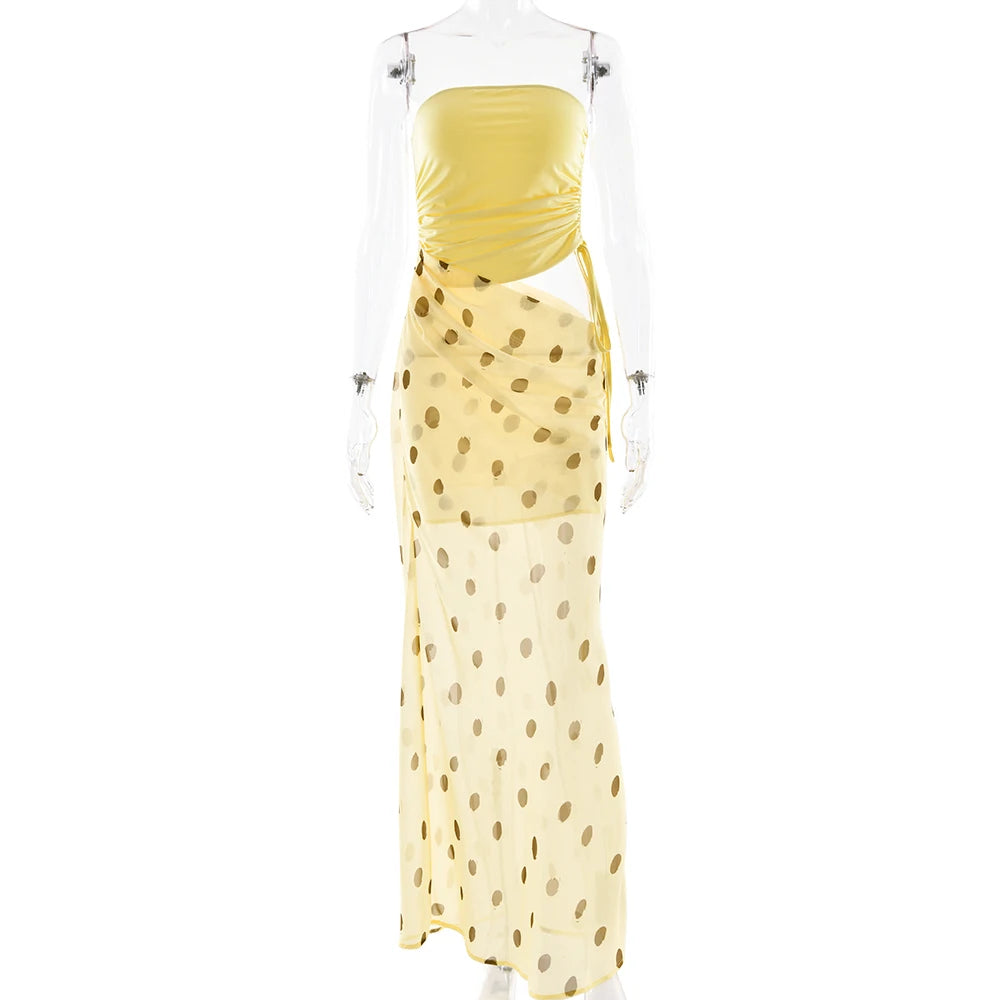 Yellow polka dot dress with a clear plastic cover on a white background