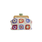 Colorful crochet clutch bag with wooden frame on a white background