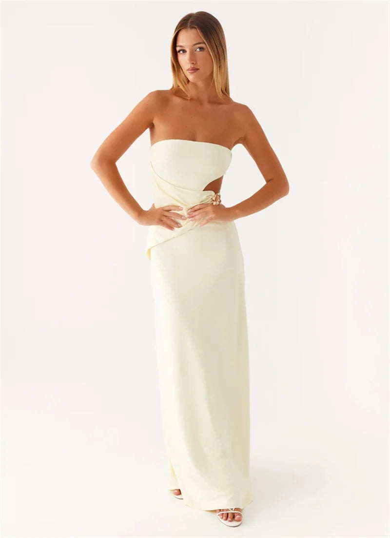 Woman wearing a strapless white gown on a white background