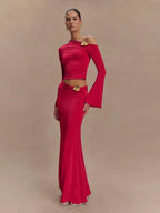 Woman wearing a red off-shoulder dress with a belt on a beige background