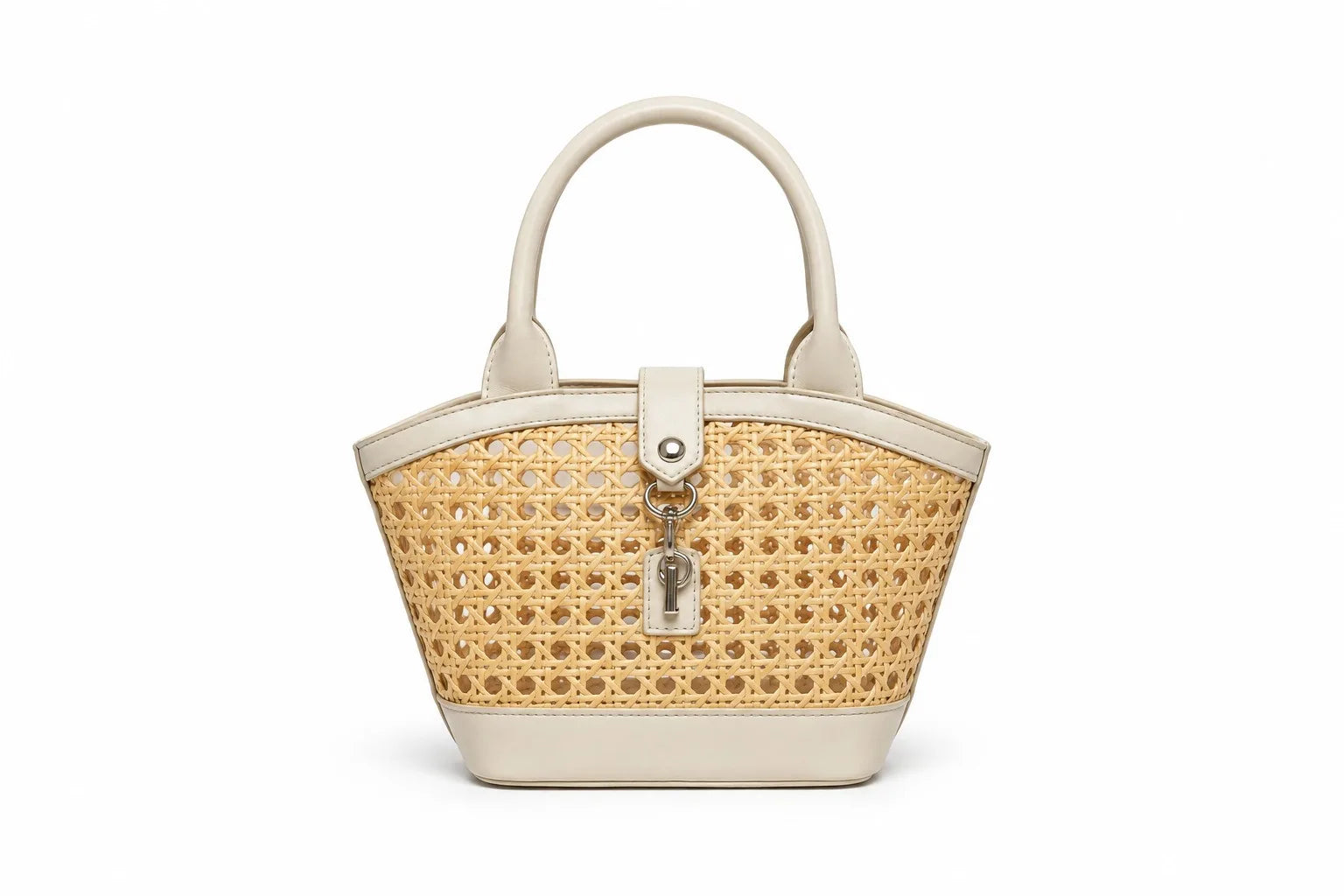 A structured handbag with a woven natural cane body and cream-colored faux leather trim, featuring dual top handles and a front turn-lock clasp with a hanging key charm, shown on a plain white background.