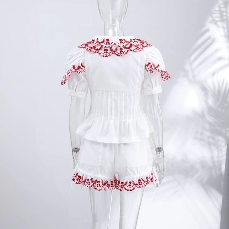 White set with red lace details on a mannequin against a white background