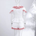 White set with red lace details on a mannequin against a white background
