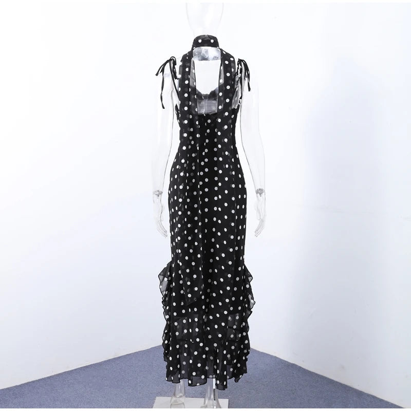 Black polka dot dress on a mannequin against a white background