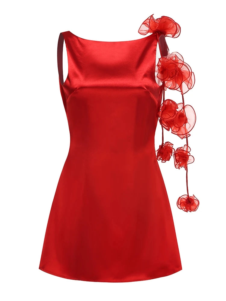 Red satin dress with floral embellishments on a white background
