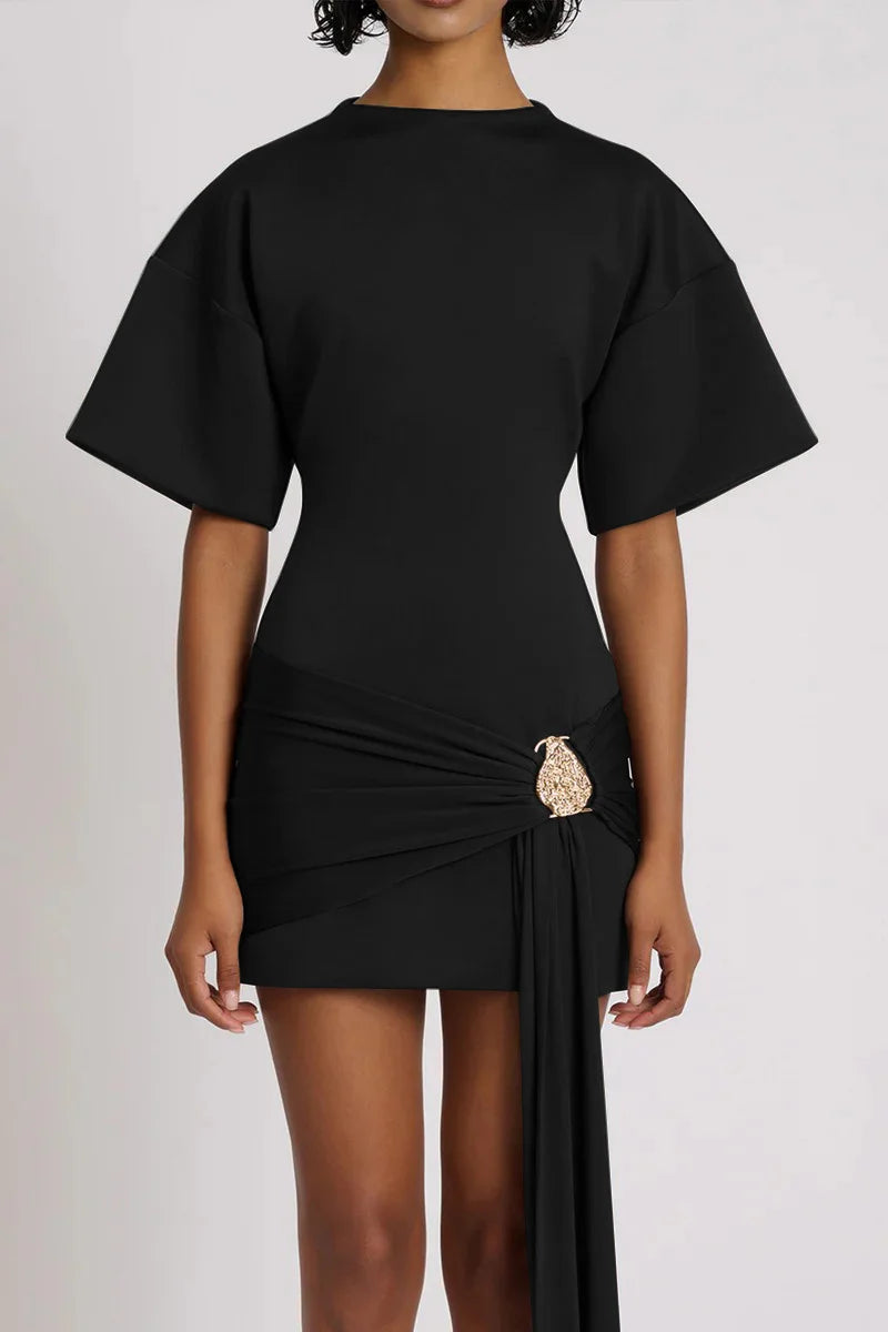 Black dress with a decorative brooch on a white background