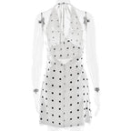 White dress with black polka dots on a white background