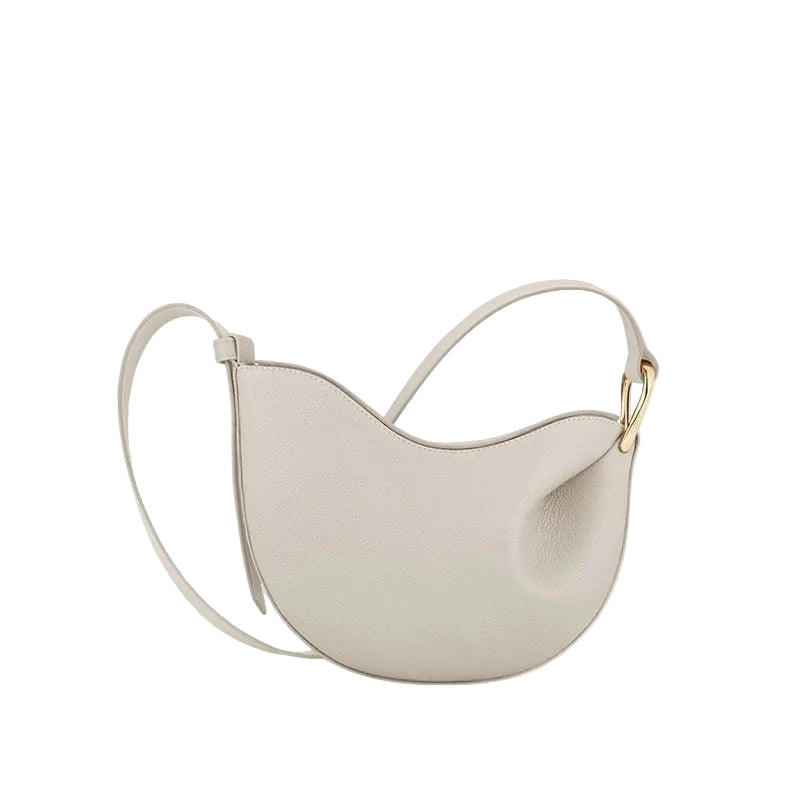 White handbag with a gold clasp on a light beige background