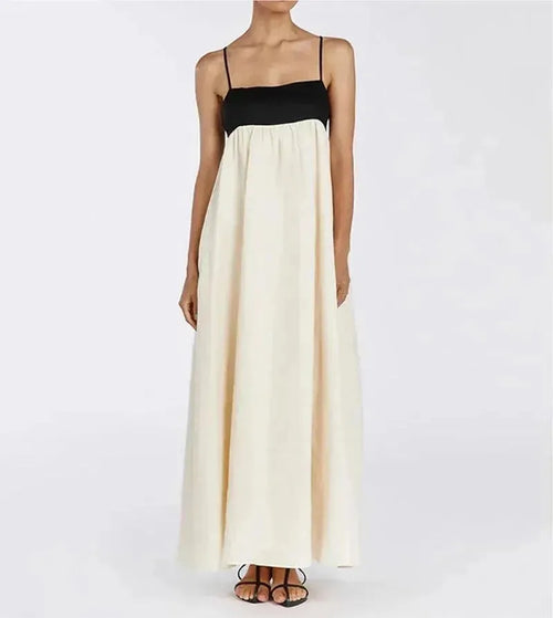 Two-tone dress with black top and white skirt worn by a model on a plain background.