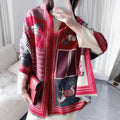 A person wearing a red, black, and white geometric patterned cashmerette scarf with a phone capturing the image.