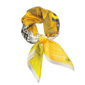 A multicolored floral silk scarf with a sunburst pattern, predominantly yellow and black, tied in a knot.