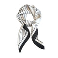 A white and black striped silk scarf tied in a knot, displayed against a white background.