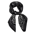 A black silk scarf with a paisley pattern, tied in a knot.