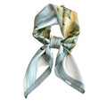 Aqua Bloom Scarf, a headband with a floral pattern, primarily in shades of blue and white.