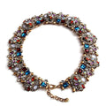 A multicolored rhinestone choker necklace with a metallic clasp.